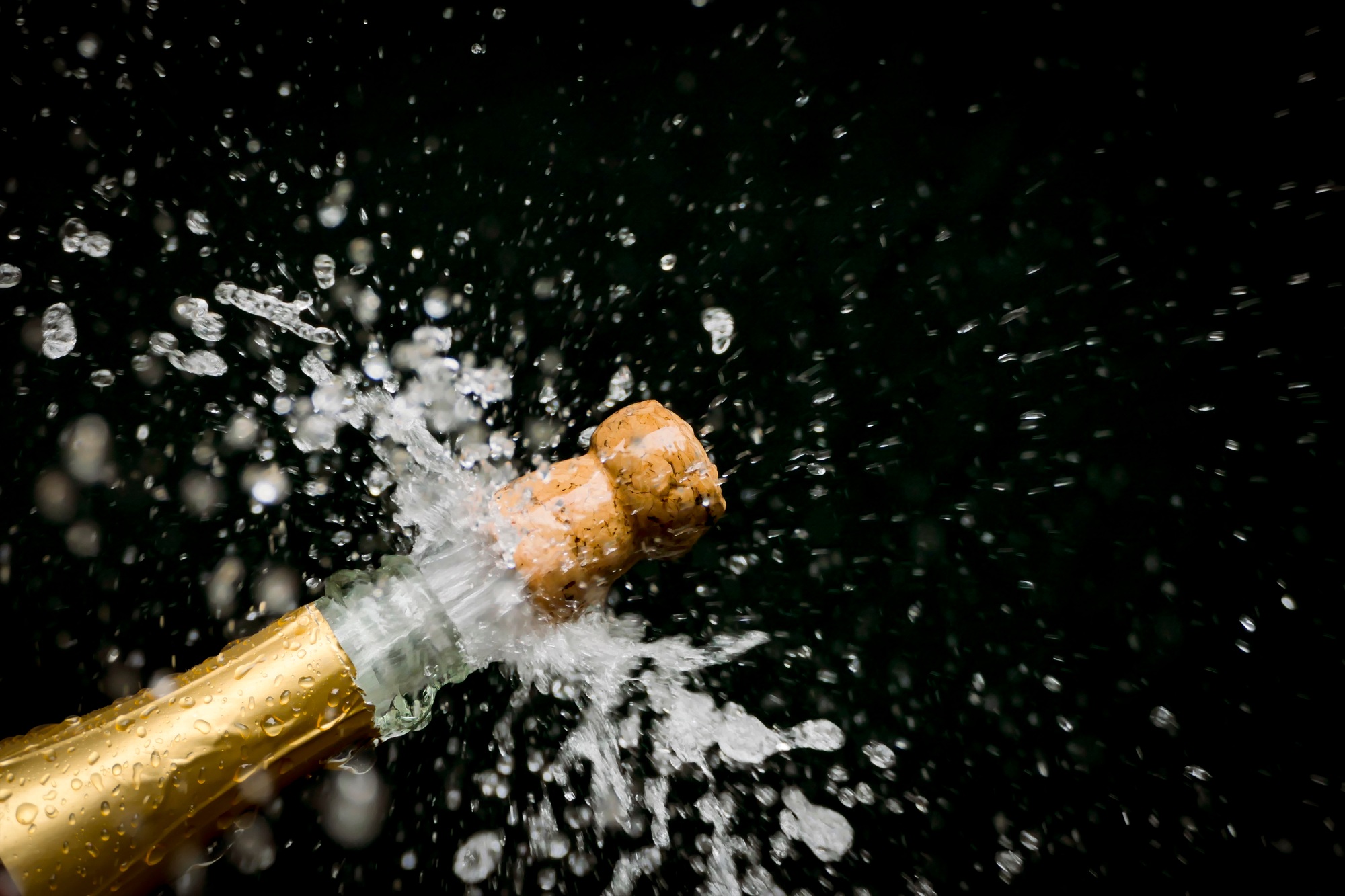 a champagne cork is popping out